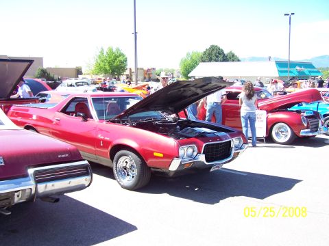1972 Ford Ranchero - A red 1972 Ford Ranchero is displayed with its hood open at an outdoor car show.