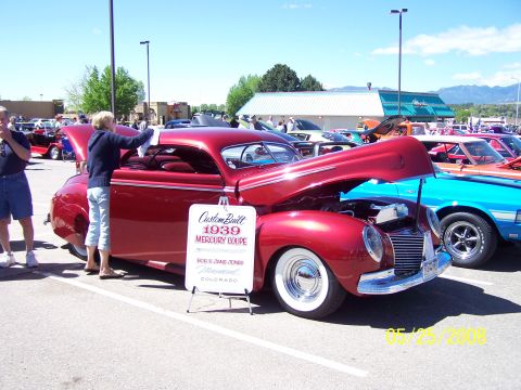 1972 Ford Ranchero - A red 1939 Mercury Coupe is displayed with its hood open at a car show.