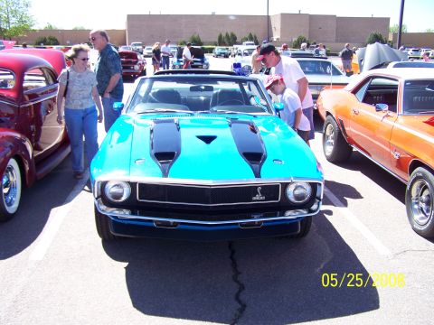1972 Ford Ranchero - A bright blue muscle car is parked at a car show with other vehicles around it.
