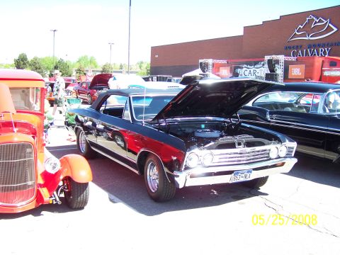 1972 Ford Ranchero - Black 1967 Chevrolet Chevelle SS convertible at a car show, hood open. Another car is to the left.