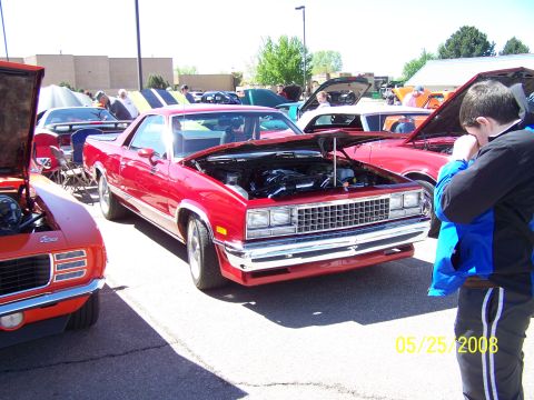 1972 Ford Ranchero - A red pickup truck with its hood open is displayed at an outdoor car show.