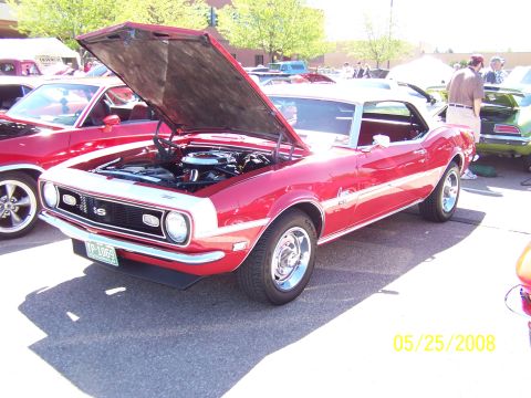 1972 Ford Ranchero - A red 1968 Chevrolet Camaro SS is displayed with its hood open at an outdoor car show.