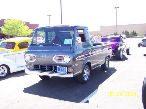 1972 Ford Ranchero - A gray Ford Econoline pickup truck is parked at a car show next to other vehicles.