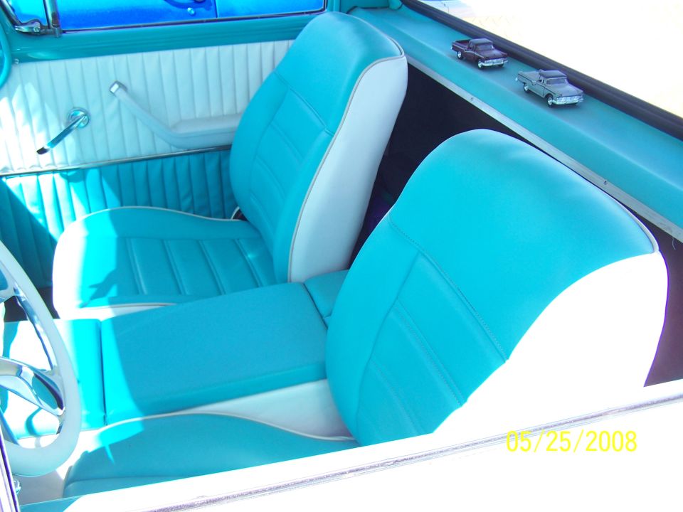 Turquoise and white interior with bucket seats and a center console. Date stamp reads 05/25/2008