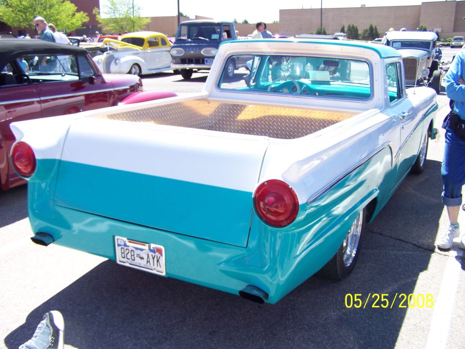 Teal and white 1957 Ford Ranchero at an outdoor car show