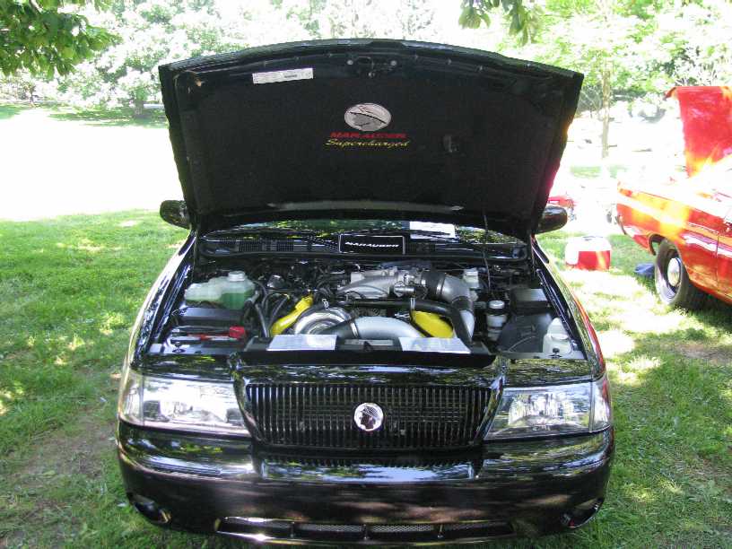 Black Mercury Marauder with hood open showing supercharged engine.