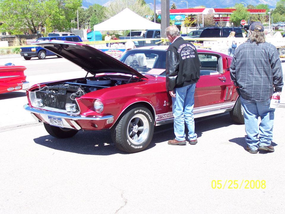 Red Shelby GT500 Mustang fastback with hood up