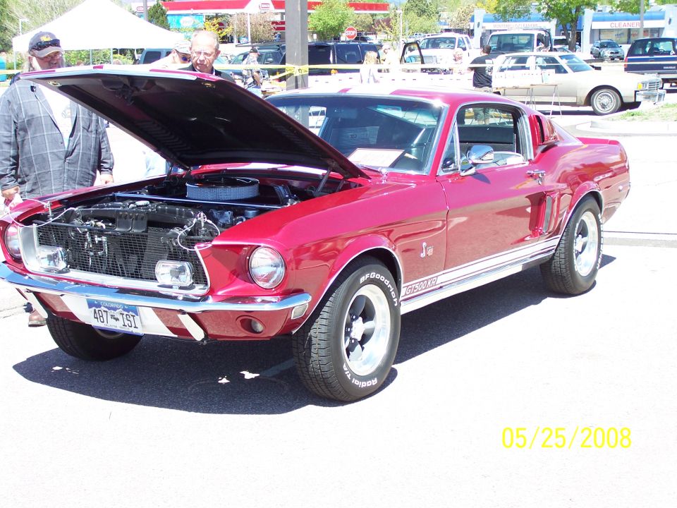 Red Shelby Mustang GT fastback with open hood