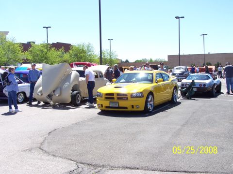1972 Ford Ranchero - A bright yellow Dodge Charger SRT8 is parked at a car show, with other vehicles visible in the background.