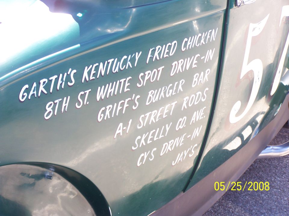 Green vehicle side with white text listing businesses and number 57