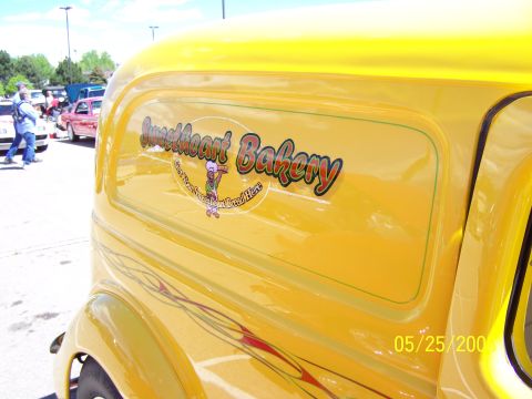 1972 Ford Ranchero - A yellow panel van with "Sweetheart Bakery" branding and custom pinstriping is seen at a car show.