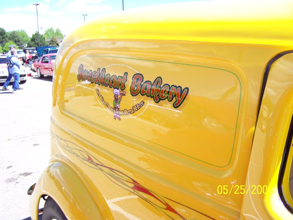 Yellow panel van side view with "Sweetheart Bakery" logo and pinstriping
