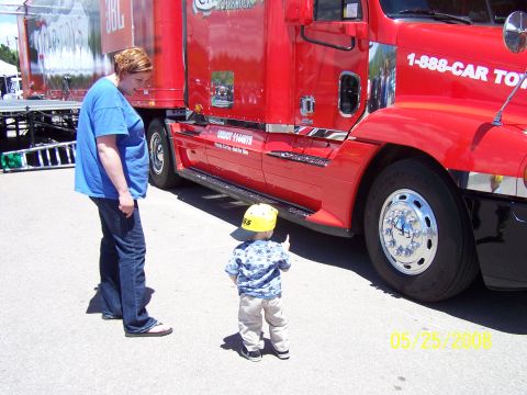 1972 Ford Ranchero - A red semi-truck is parked, with a woman and child looking at it. The date 05/25/2008 is visible.