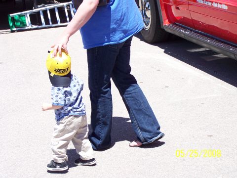 1972 Ford Ranchero - A child wearing a yellow JEGS helmet walks beside a red vehicle, with a date stamp of 05/25/2008 visible on the pavement.