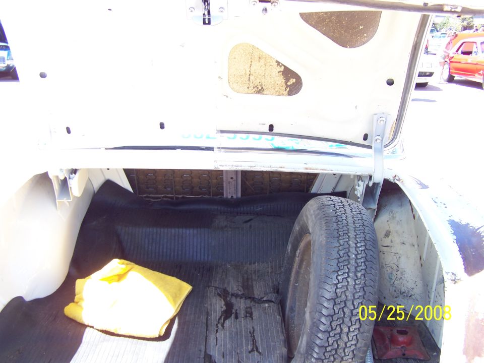 Trunk interior with spare tire and yellow cloth. Date stamp 05/25/2009
