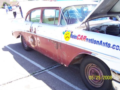 1972 Ford Ranchero - This weathered sedan displays a prominent decal on its door, with a date stamp of 05/25/2008 visible on the wheel.