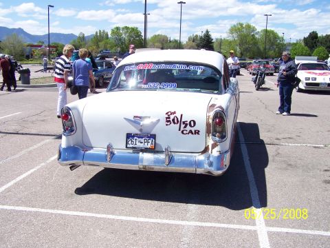 1972 Ford Ranchero - A classic 1955 Chevrolet Bel Air is parked at an outdoor car show, displaying a website and phone number on its rear window.