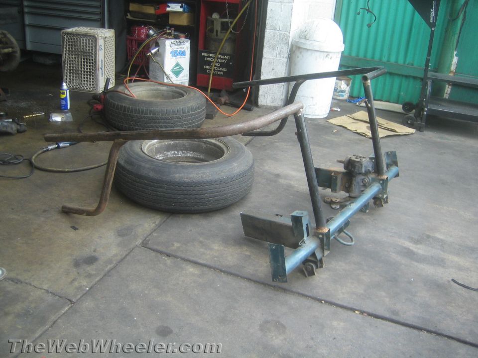 Trailer hitch assembly with two tires in the background