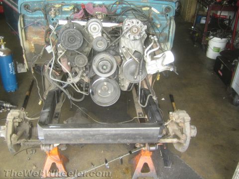 1987 Suzuki Samurai - Workshop scene showing engine and front suspension components disassembled and supported by jack stands.