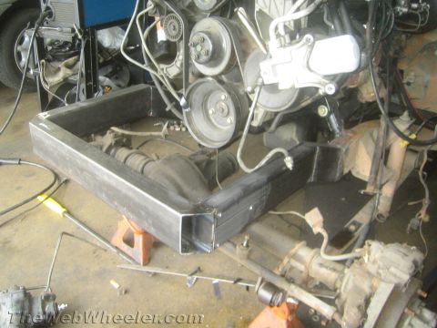 1987 Suzuki Samurai - Custom frame fabrication is underway, showing the engine and rear axle assembly in a workshop setting.
