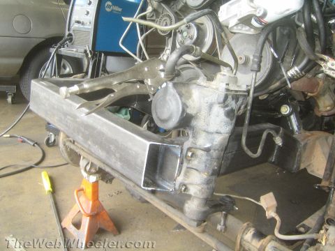 1987 Suzuki Samurai - Close-up view of steering rack and suspension components, possibly undergoing fabrication or repair.