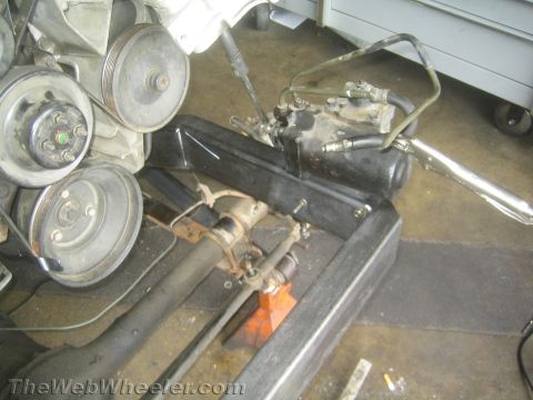 1987 Suzuki Samurai - Close-up of engine pulleys and steering components, possibly during a repair or restoration.