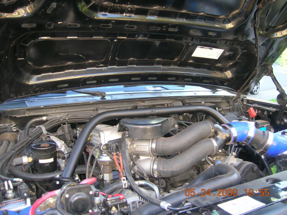 Engine bay with twin turbo intake pipes and intercooler piping