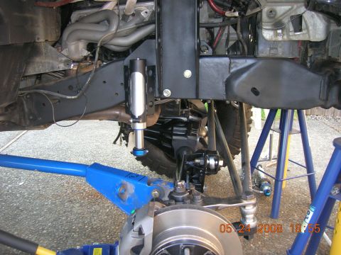 1996 Ford Bronco - Vehicle suspension and steering parts are visible, supported by jack stands.