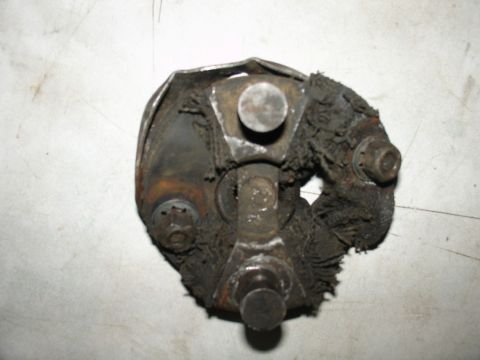 1978 Ford Bronco - A heavily worn universal joint shows significant damage to its rubber boot and rusted metal parts.