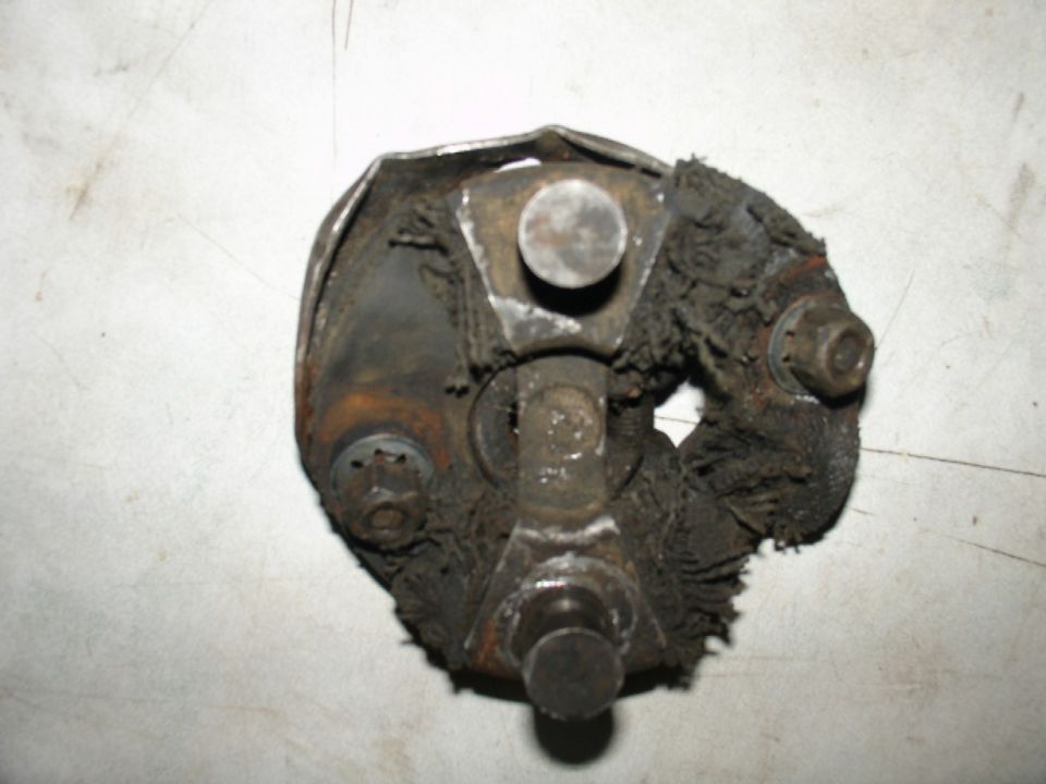 Worn universal joint with frayed rubber boot and rusted metal components