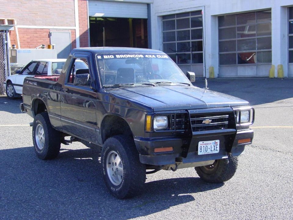 Black lifted Chevrolet S10 Blazer with brush guard, front 3/4 view