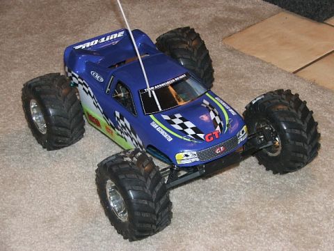 2000 Nissan Frontier - This blue remote control monster truck features racing graphics and oversized tires, suggesting it is a toy rather than a production vehicl…