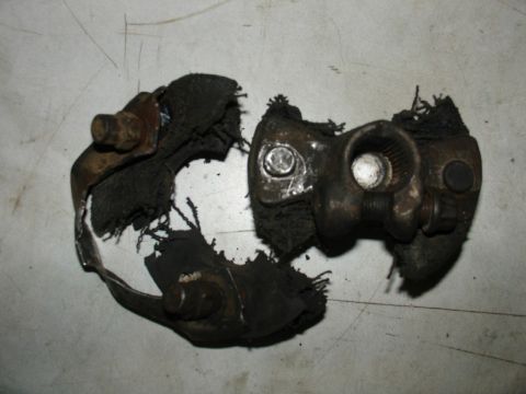 1978 Ford Bronco - Damaged automotive part with torn rubber and corroded metal components.