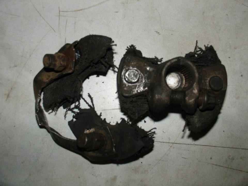 Two broken pieces of a rubber and metal automotive part, possibly a suspension component