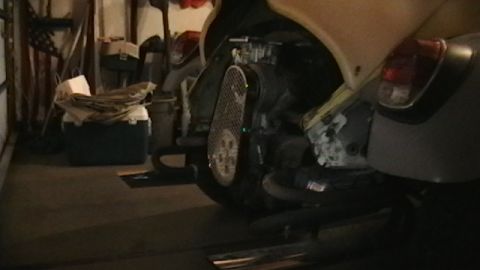 1970 Volkswagen Beetle - The engine compartment of a 1970 Volkswagen Beetle is visible, the fan shroud and carburetor.