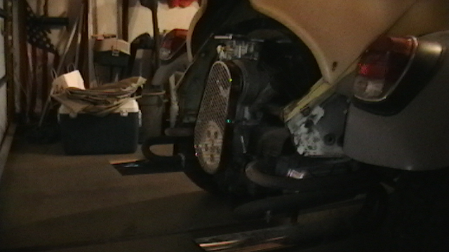 Engine compartment of a 1970 Volkswagen Beetle, showing the fan shroud and carburetor