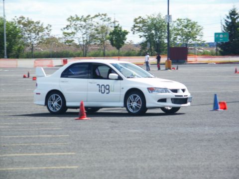 2001 Mercury Grand Marquis - White sedan with racing number 709 on door, parked on asphalt with cones.
