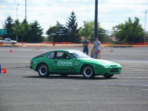 2001 Mercury Grand Marquis - Green sports car with racing decals parked on a paved lot with cones.