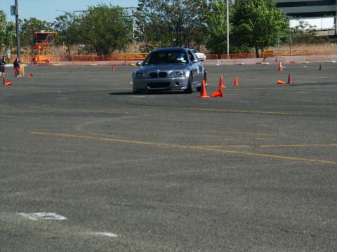 2001 Mercury Grand Marquis - Silver BMW M3 E46 navigates a course marked by orange cones on a paved lot.