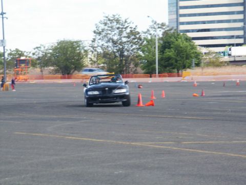 2001 Mercury Grand Marquis - A black convertible sports car navigates a course marked by orange cones.