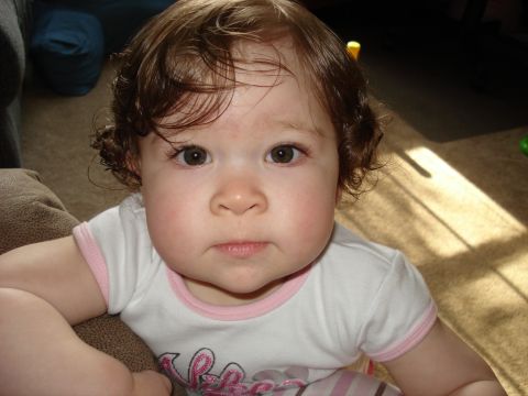 2000 Ford Crown Victoria - Close-up of a baby's face with sunlight casting shadows on the carpeted floor.