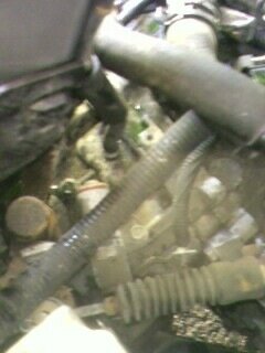 2002 Nissan SE-R - Close-up view of engine components, including various hoses and tubing, with a website watermark.