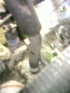 2002 Nissan SE-R - A close-up view of a vacuum line, with the SuperMotors logo in the lower right corner.