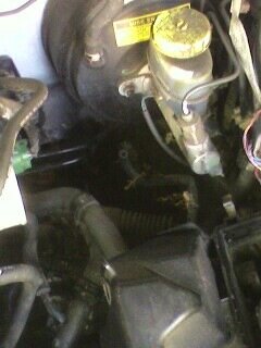 2002 Nissan SE-R - Close-up of brake master cylinder and vacuum booster assembly.
