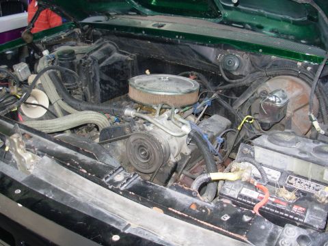 1975 Ford Bronco - The engine bay of a vehicle, showing the V8 engine and associated components.