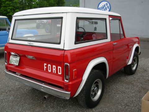 1975 Ford Bronco - Rear view of a red 1975 Ford Bronco with a white hardtop.