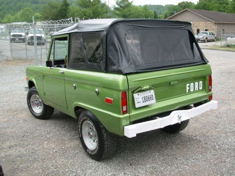 1975 Ford Bronco - This 1975 Ford Bronco features a soft top and a white rear bumper, seen from a rear three-quarter angle.
