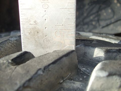 1978 Jeep Cherokee - A ruler measures the tread depth of a tire, indicating a measurement of about 1.5 inches.