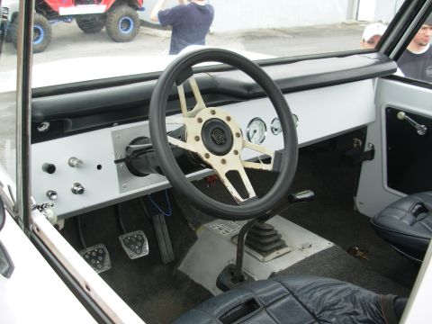 1975 Ford Bronco - Interior of a 1975 Ford Bronco, with another vehicle visible outside.