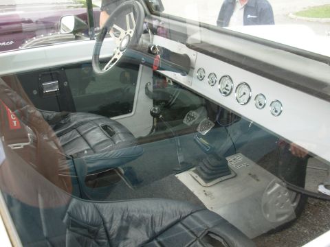 1975 Ford Bronco - The custom interior of a Ford Bronco features aftermarket gauges and racing seats.